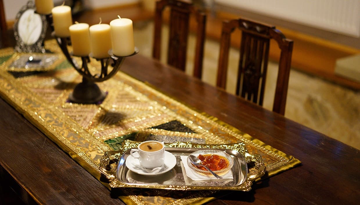 Greek coffee and a spoon sweet served on a silver tray