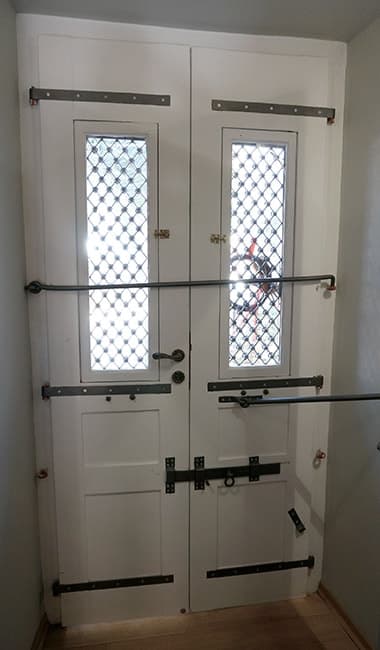 The original entrance doors, still fitted with their iron safety crossbars